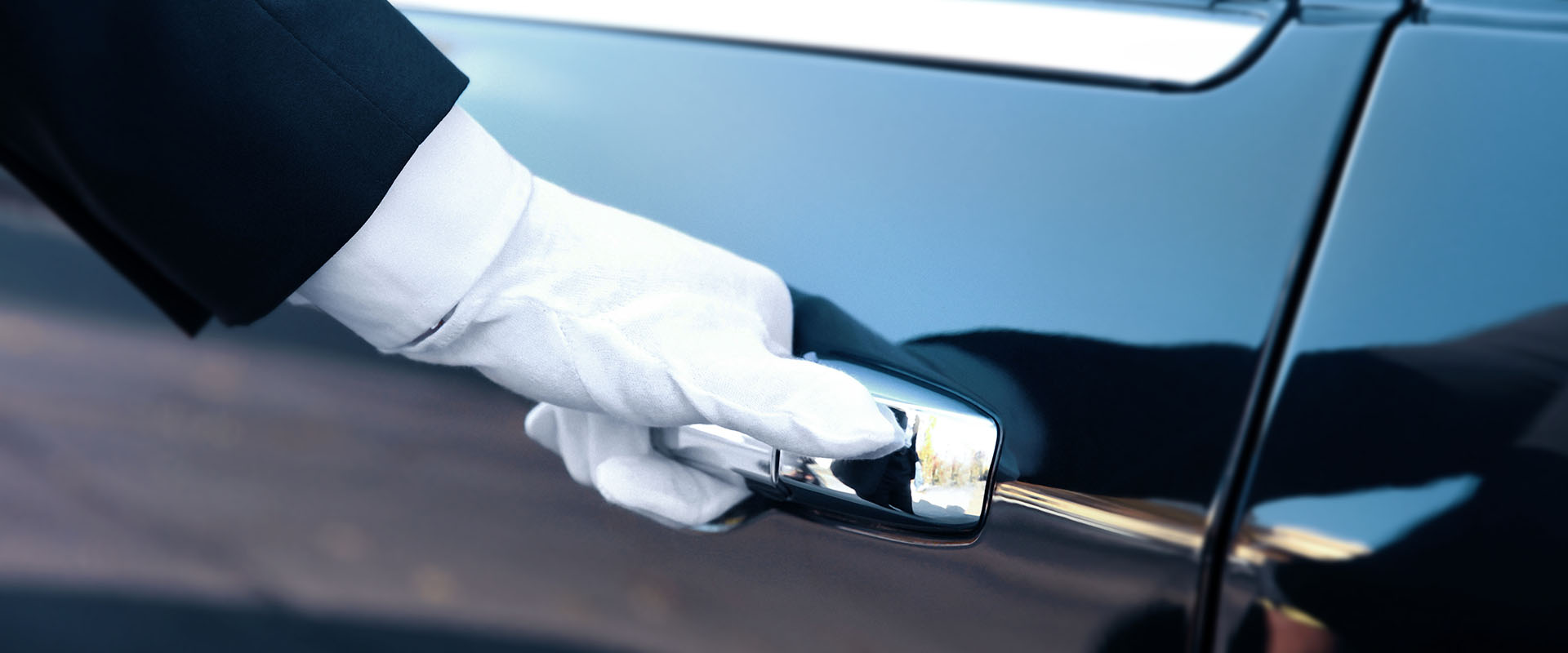 valet's hand in white glove opening car door